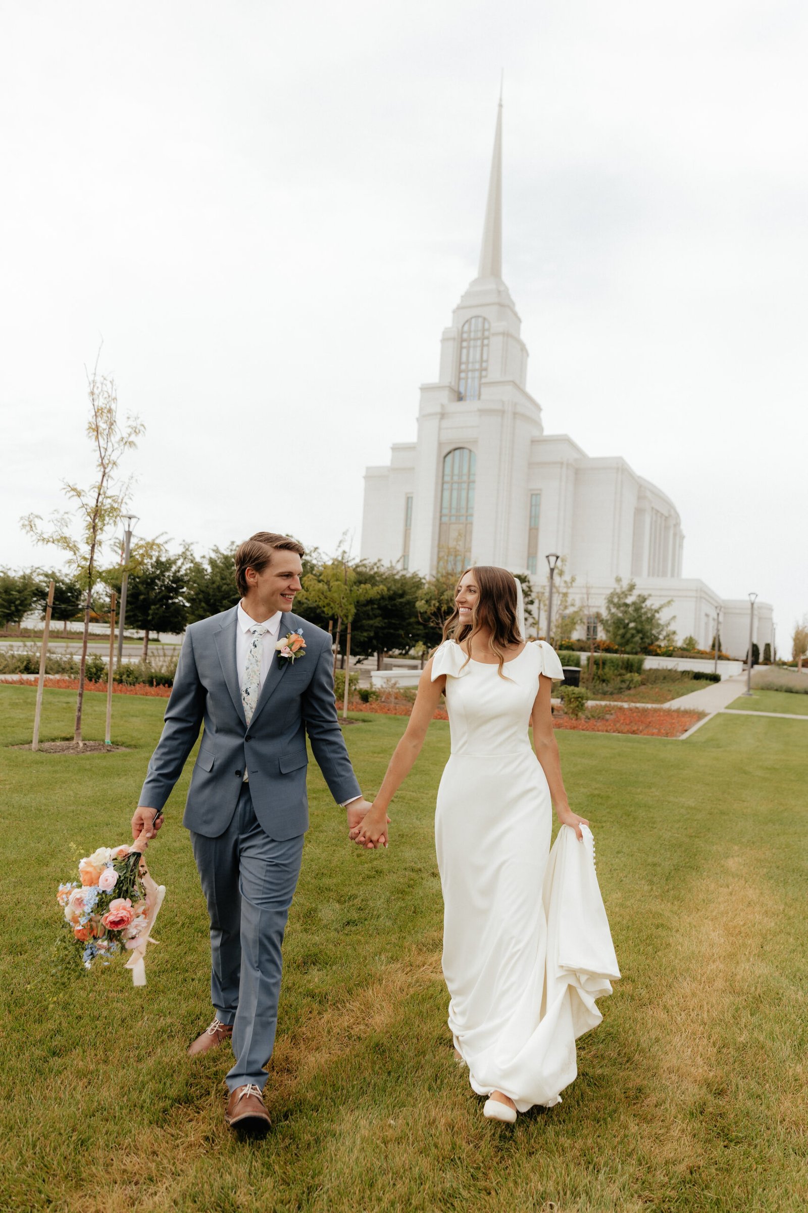 Bride and groom in a green field