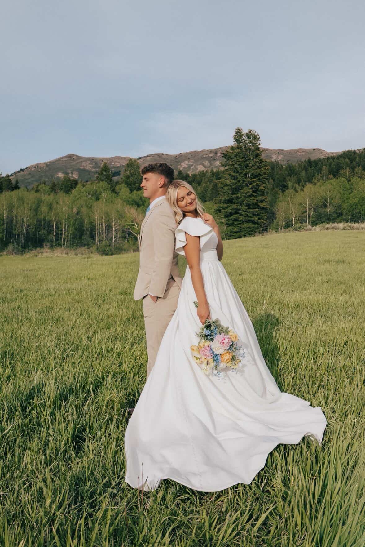 Bride in a flowing wedding gown in a Utah field