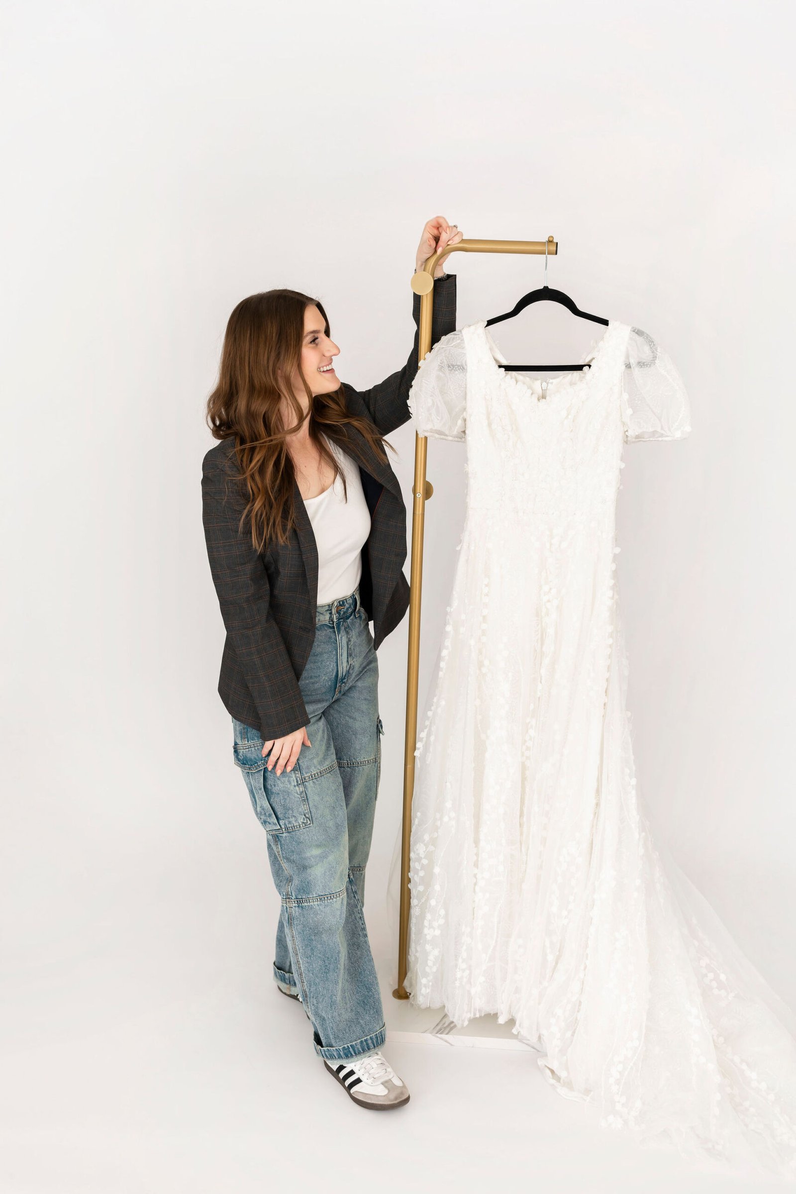 Owner of Laurels and Lace holding a wedding gown