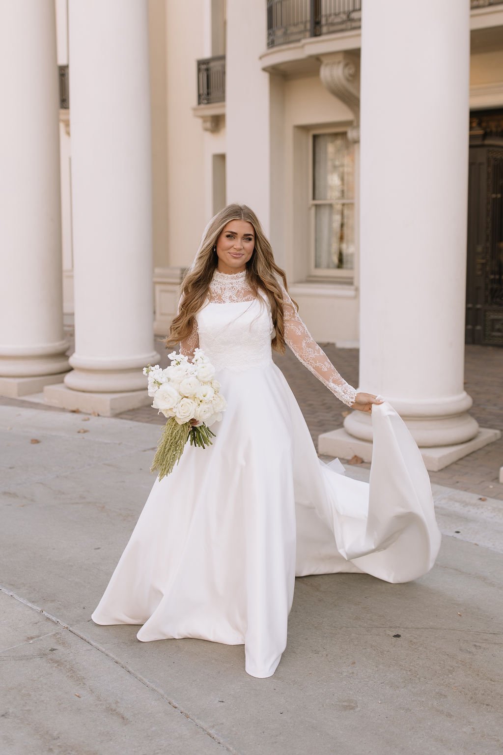 Bride in a modest lace sleeve wedding gown